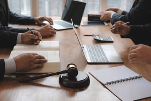 Law firm office manager reviewing HR compliance documents — Helpside PEO for law firms